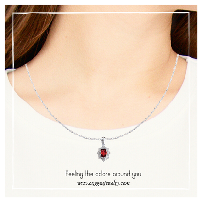 Oval garnet and round zirconia necklace