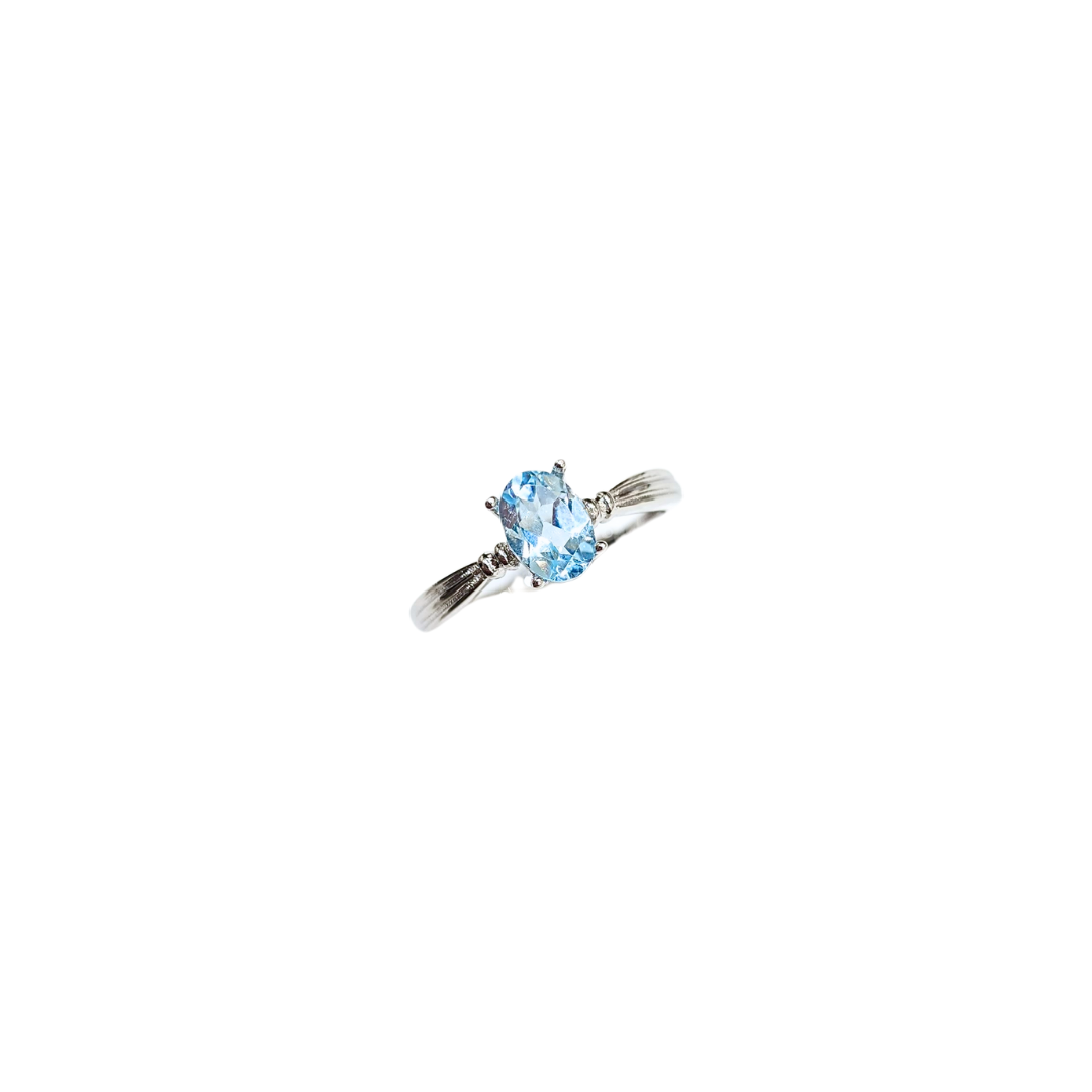 Oval Sky Blue Topaz Ring with Round Zirconia