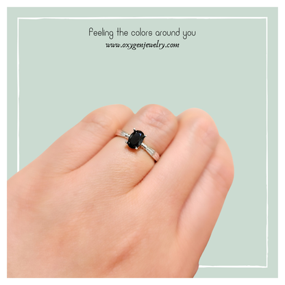 Oval black spinel and round zirconia ring